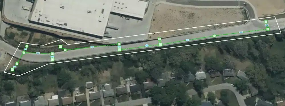 Aerial view of a mapped sewer line in SiteMap® showing geolocated pipe segments, inspection points, and alignment within a residential and commercial area.